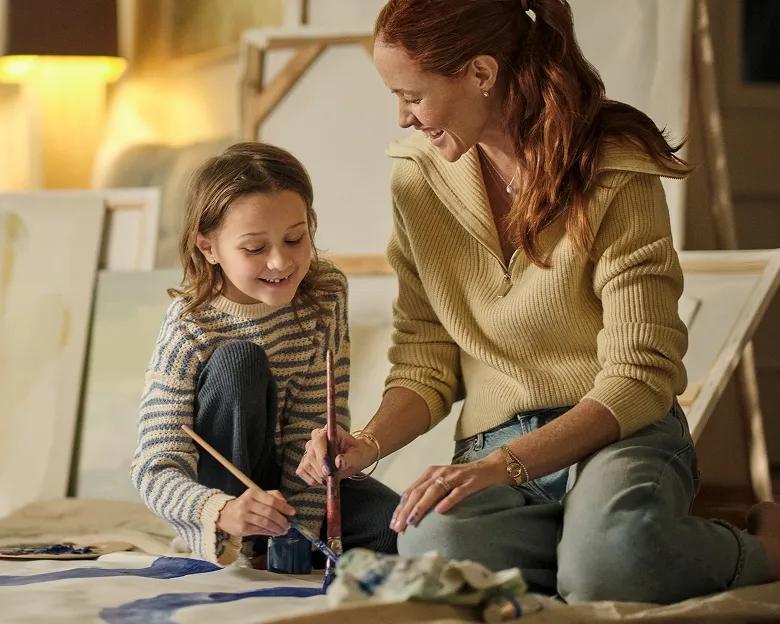 An image of a mother and daughter painting